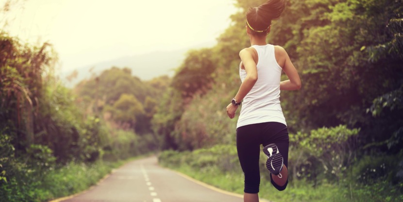 young fitness woman runner running on trail