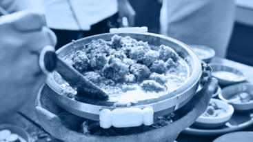 Close up shot of man stirring tajine during Moroccan cooking class