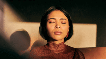 Vrouw heeft ogen dicht en kijkt in het licht